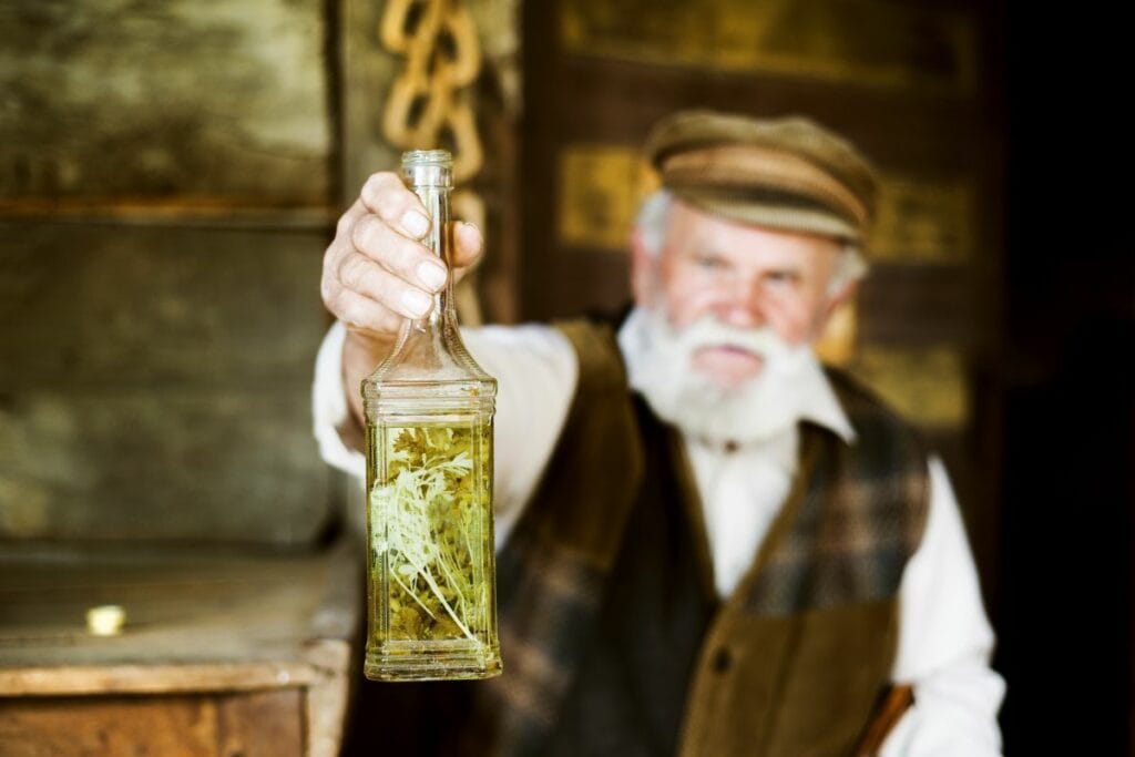 an old man holding a bottle of aquavit